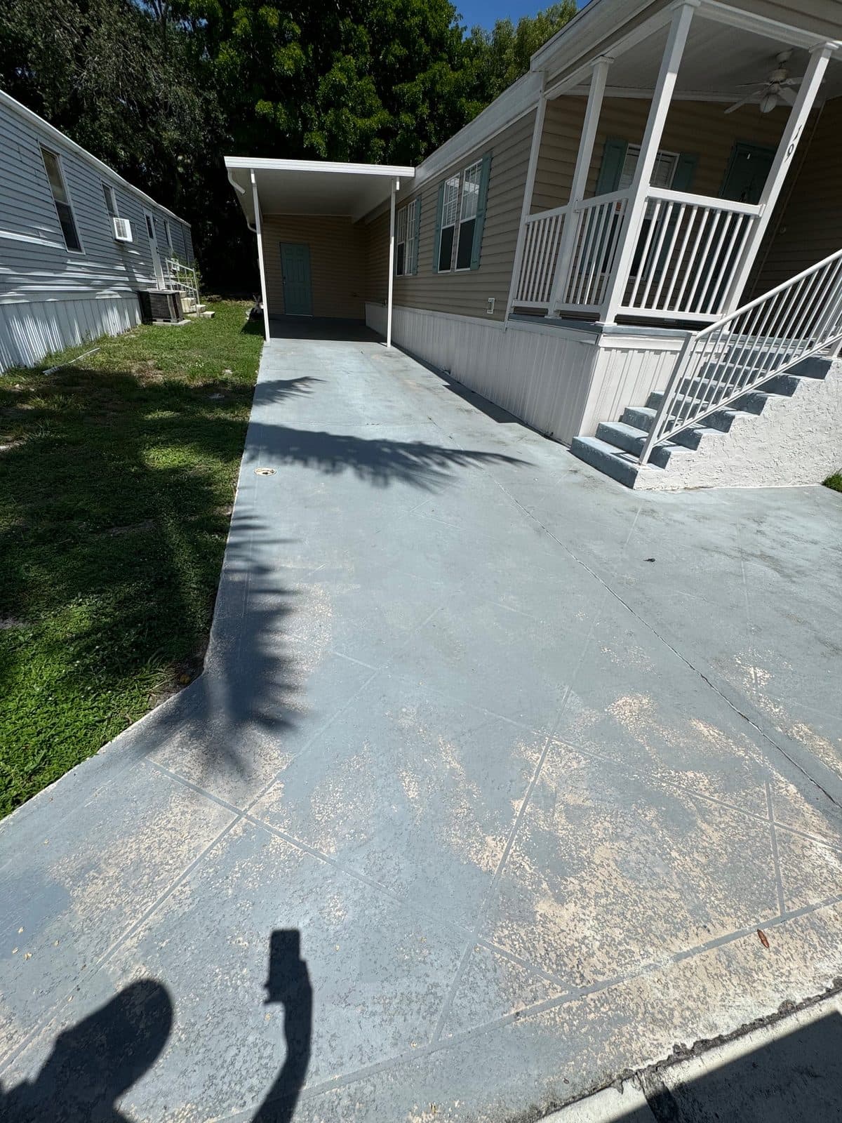 Clean concrete driveway and walkway after pressure washing
